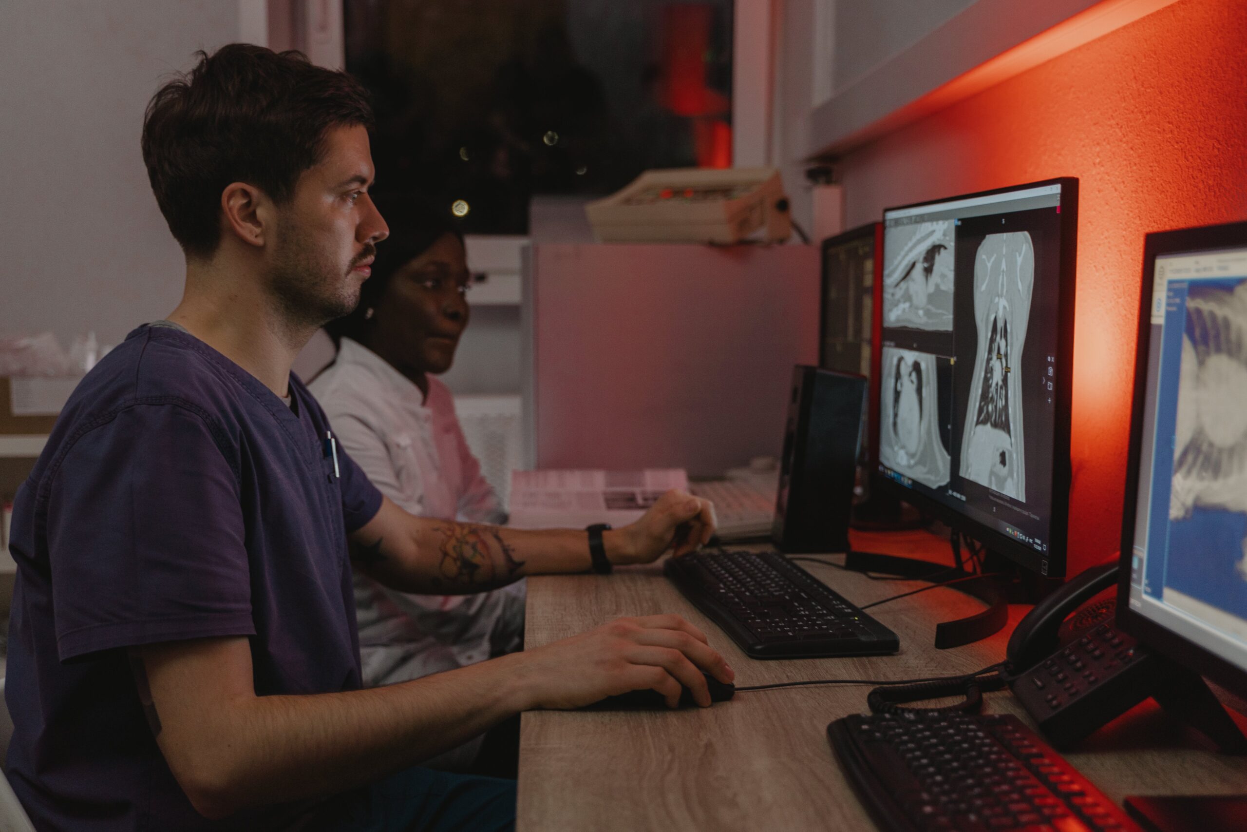 Medical students studying X-ray images on a computer screen in a lab setting