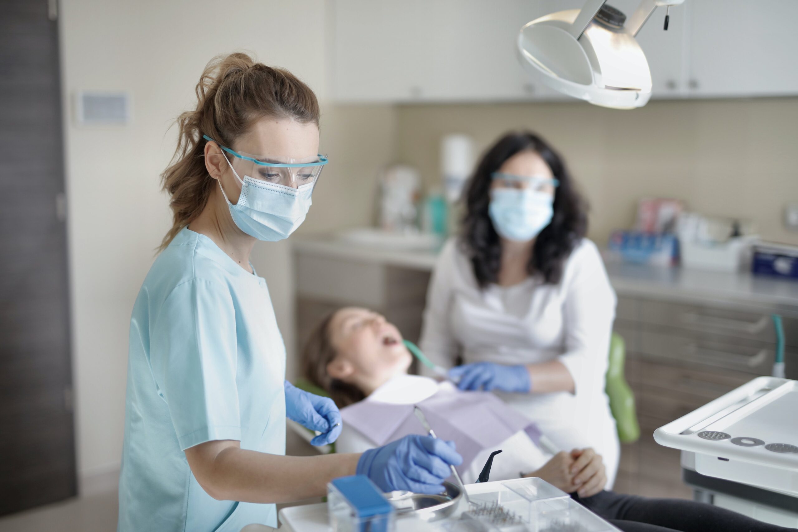 Dentist cleaning a patient's teeth with professional dental tools for a thorough oral care treatment