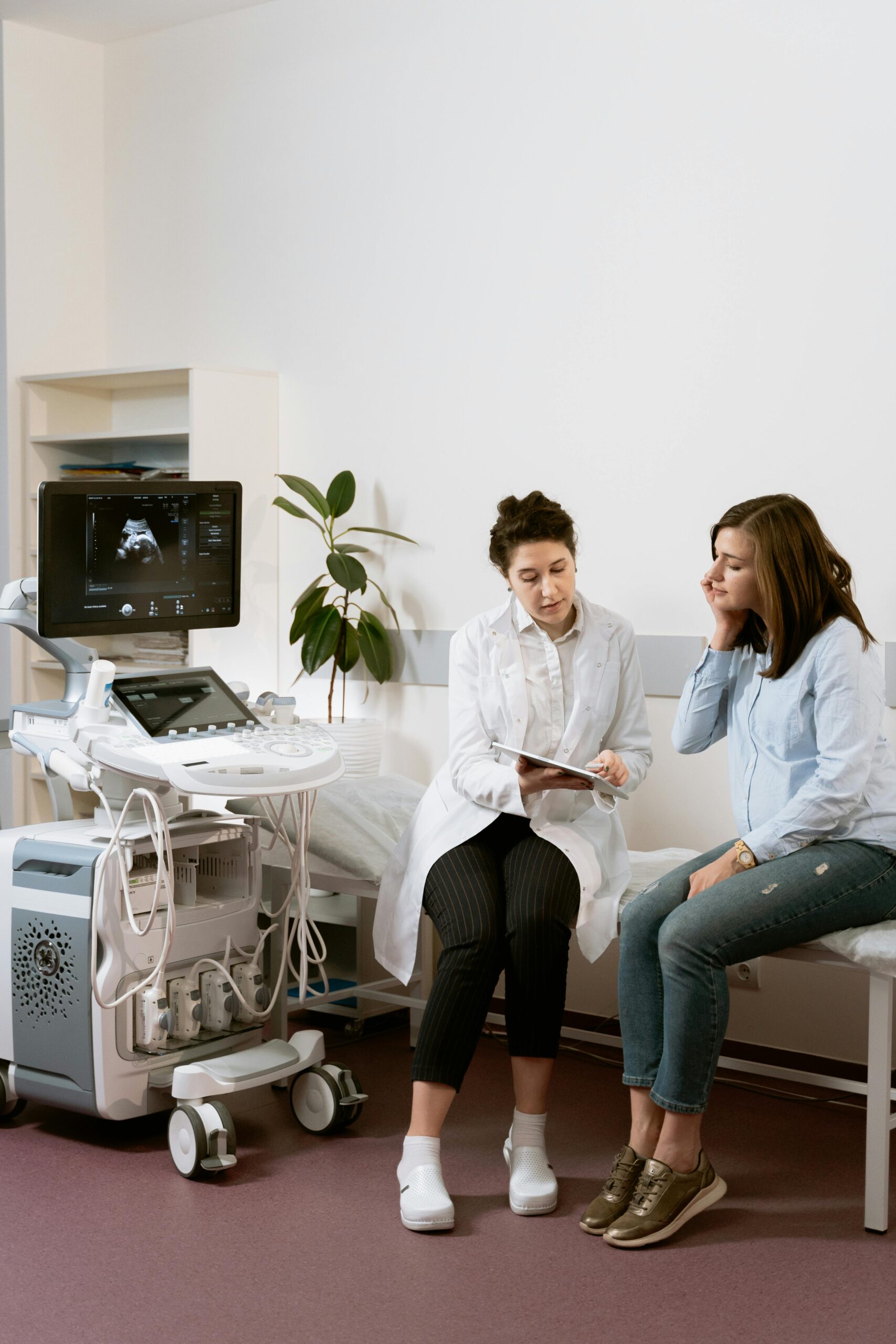 Doctor reviewing ultrasound results with a patient, explaining findings and discussing next steps