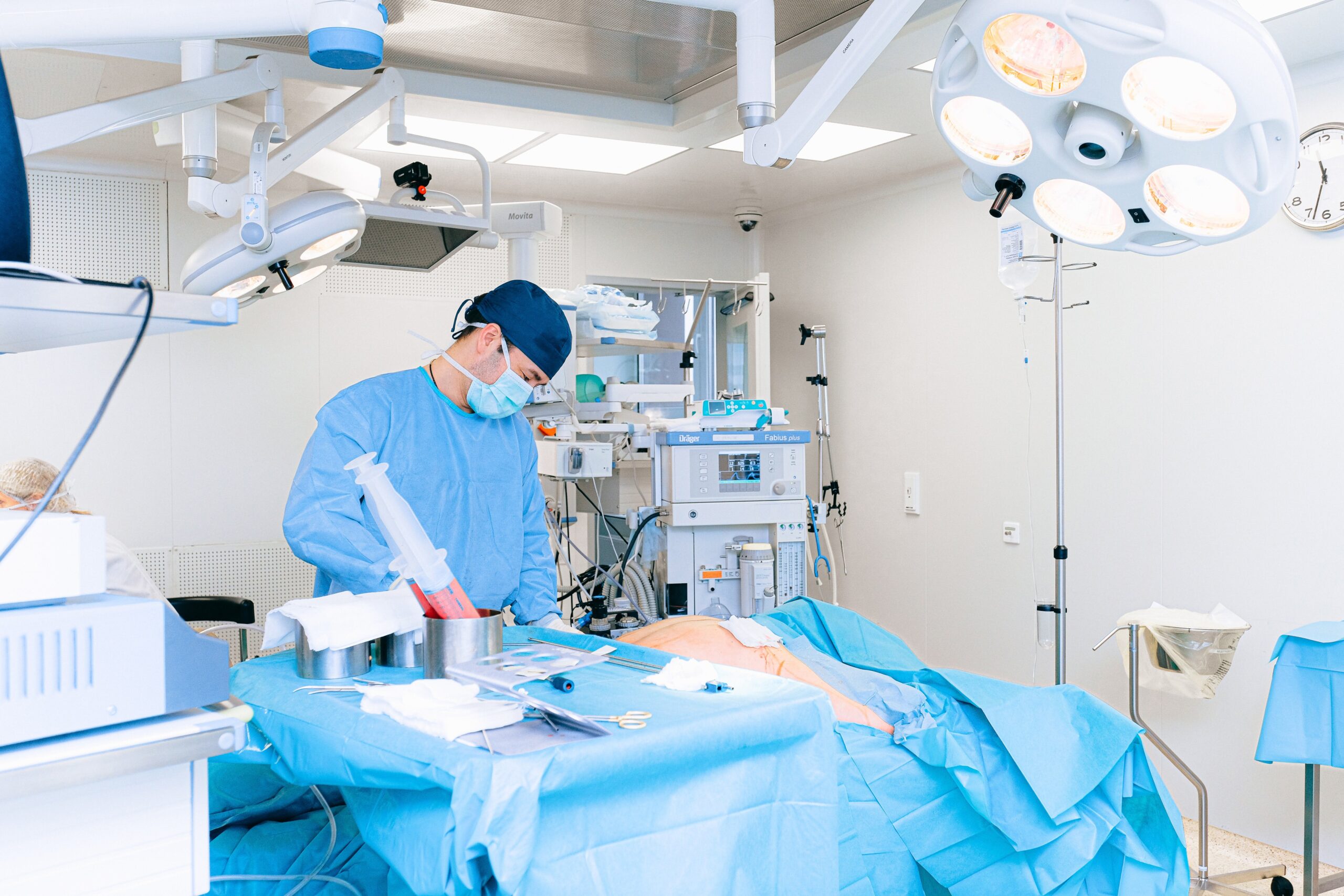 ER operating room with surgery in progress, featuring surgeons, medical instruments, and advanced equipment