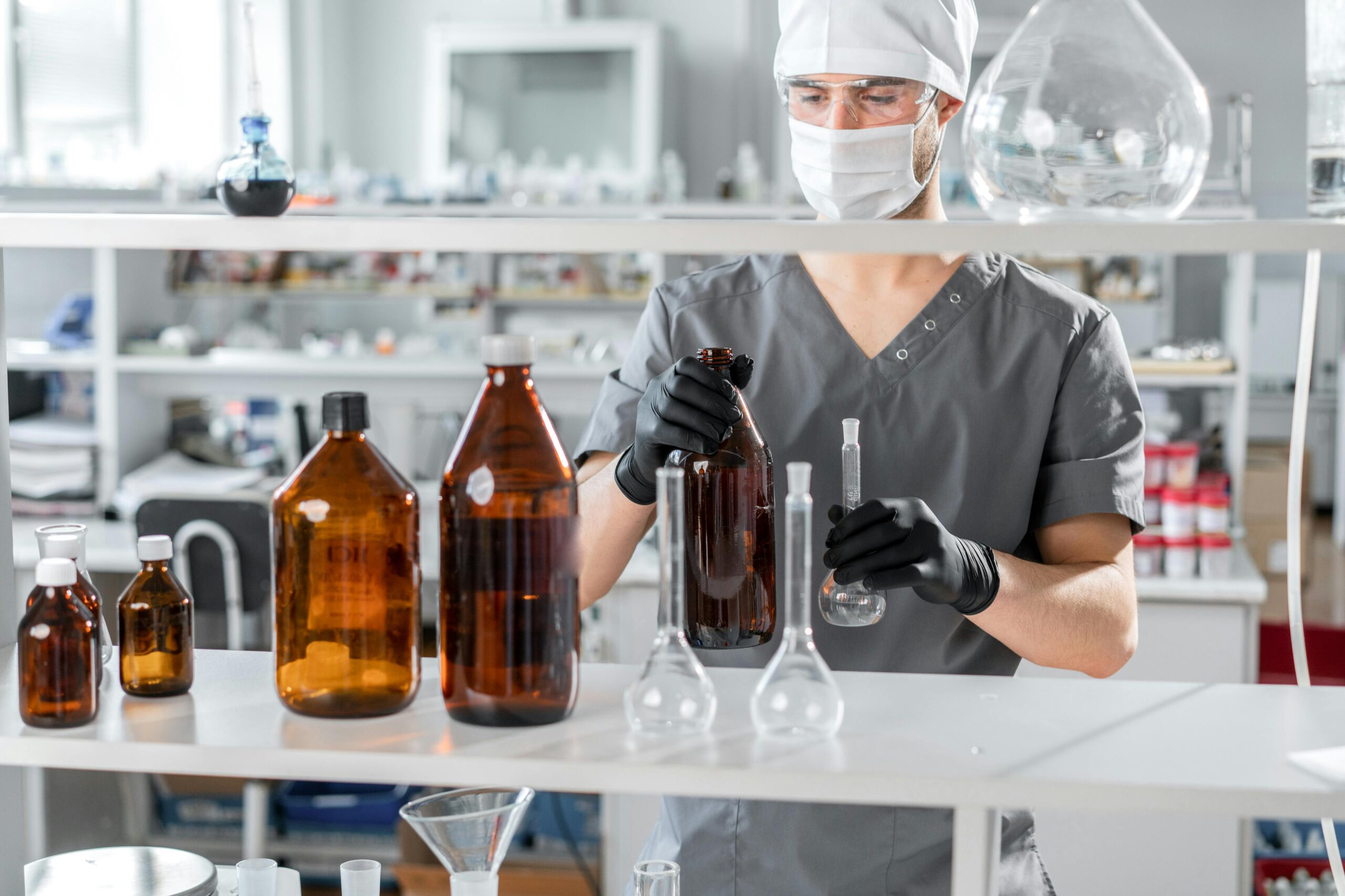 Lab technician preparing chemical solutions in a laboratory for testing and analysis