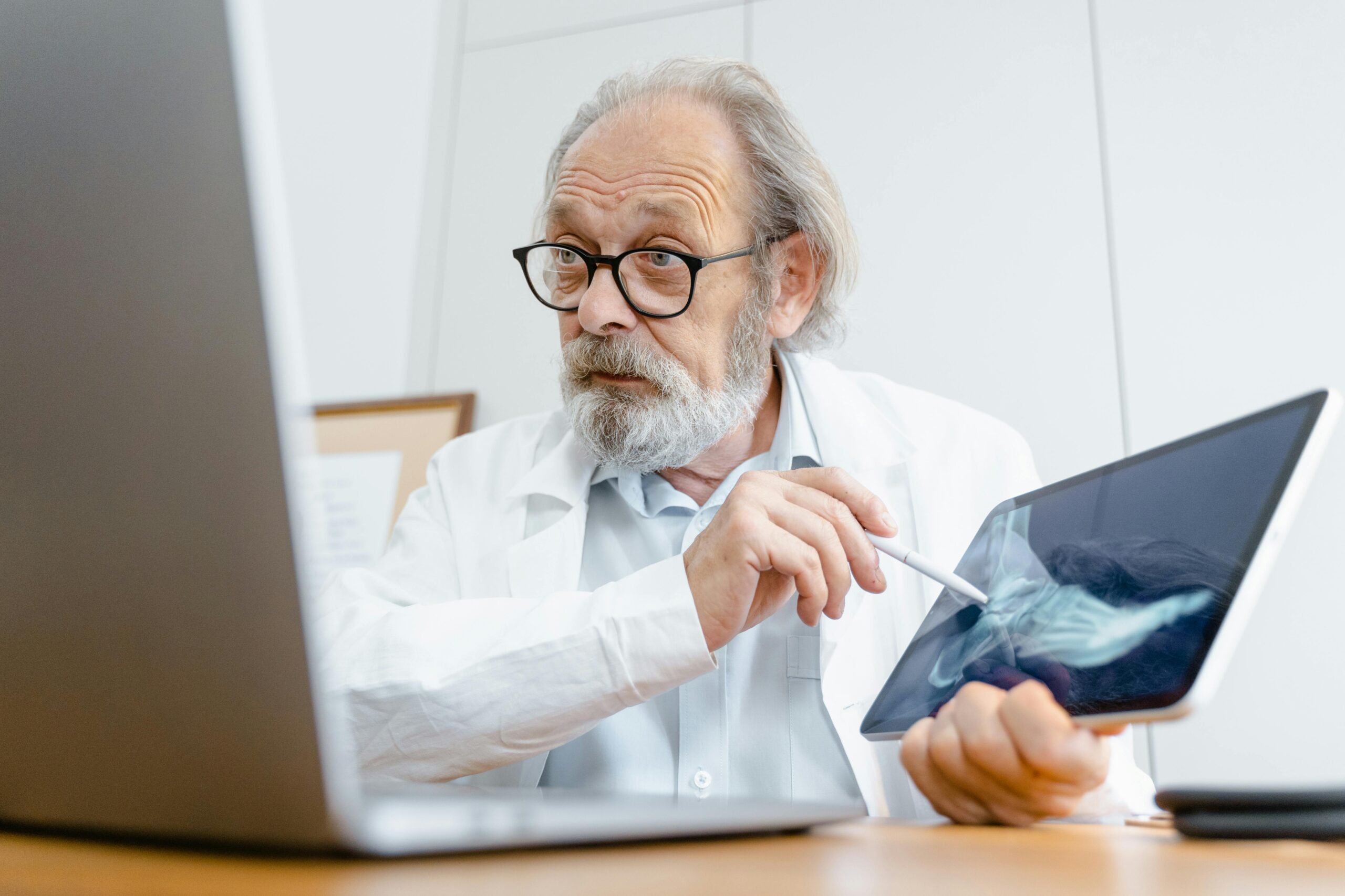 Doctor examining a foot X-ray with a patient to diagnose and discuss treatment options